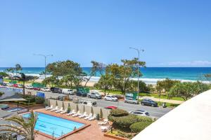 a view of the beach from the balcony of a resort at Focus Apartments in Gold Coast