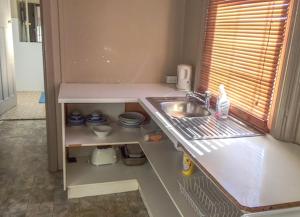 a kitchen with a sink and a counter top at Commercial Hotel Motel Lithgow in Lithgow