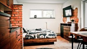 a bedroom with a bed and a brick wall at my inn in Chemnitz