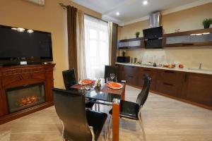 a dining room with a table and a fireplace at PaulMarie Apartments on Prs. Lenina, 51 in Gomel