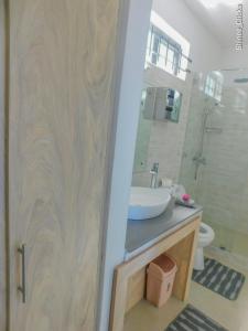 a bathroom with a sink and a mirror at Fullmoon Apartment & Studio in La Gaulette