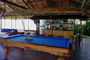 a pool table in a restaurant with a bar at Romantic Beach Villas in General Luna