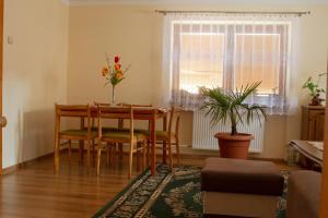a dining room with a table and chairs and a window at Privat BAJKA in Spišské Bystré