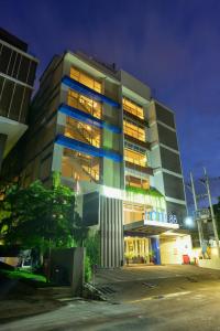 a building with lights on in a city at night at Hotel 88 Embong Kenongo - Kayun By WH in Surabaya