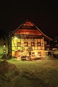 a large house with a lit up at night at Dreibettzimmer-in-Wiesa in Thermalbad Wiesenbad