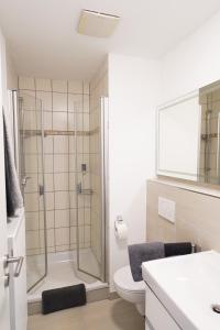 a bathroom with a shower and a toilet and a sink at BITO CAMPUS in Meisenheim