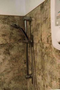 a shower in a bathroom with a shower head at Romantic Beach Villas in General Luna