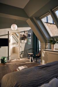 a bedroom with an attic with a bed and a window at Coco Hotel in Copenhagen