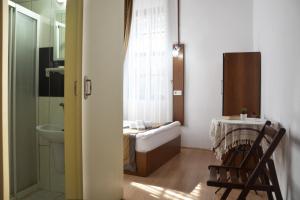a bathroom with a tub and a sink and a toilet at Konak Hotel Kaleiçi in Antalya
