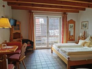 a bedroom with a bed and a large window at Gästehaus im Malerwinkel-Rhodt in Rhodt unter Rietburg