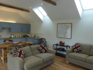 格拉斯顿伯里The Woodshed - A newly built, 2 bedroom, cottage near Glastonbury的带两张沙发的客厅和厨房