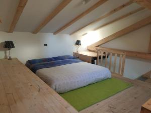 a bedroom with a bed and a wooden floor at Miniattico Fara in Milan
