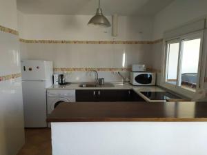 a kitchen with a sink and a refrigerator at Atico centrico ideal en Algodonales in Algodonales