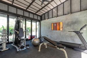 a gym with several exercise equipment in a room at Phuketa - SHA Extra Plus in Phuket Town