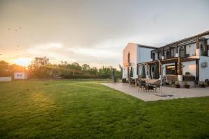 a house with a green lawn in front of it at Villa Ciao - Adults Only in Corbu +27 photos