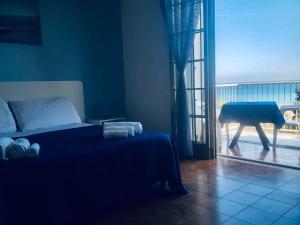 a bedroom with a bed and a view of a balcony at Le Dune camere in Otranto