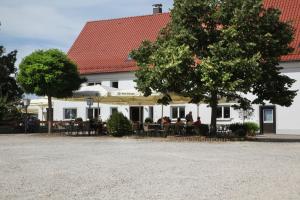 a group of people sitting at tables in front of a building at Gasthaus Hirsch in Ersingen