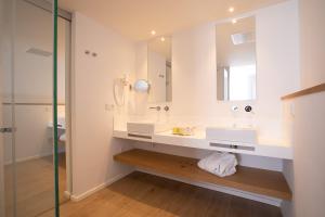 
a bathroom with a sink, toilet and bathtub at Hotel Anfora Ibiza in Es Cana
