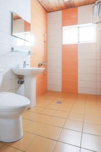 a bathroom with a toilet and a sink at Hai Yuan Bungalow II in Kenting