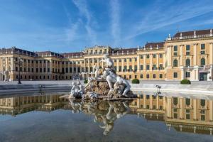 a building with a statue in the water in front of it at Premium Aufenthalt l LF23 in Vienna