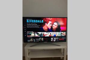 a flat screen tv sitting on top of a table at Premium Aufenthalt l LF23 in Vienna