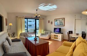a living room with a couch and a table at Zahara almadraba playa Atlanterra in Zahara de los Atunes
