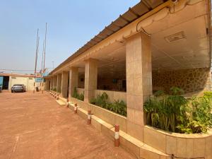 a building with plants on the side of it at Hotel Levy's in Bangui