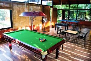 a pool table in the middle of a room at Aranyagiri Countryside Resort, Near Pune in Pune