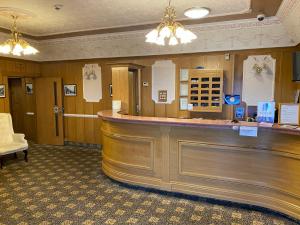 a bar in a hotel room with a counter at Bessemer Hotel in Merthyr Tydfil