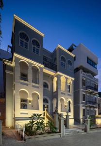 a large apartment building with lights on at Mr Allenby By TLV2GO in Tel Aviv