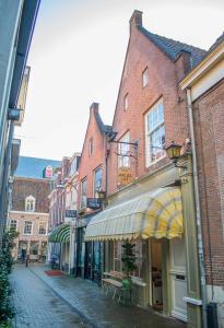 a street in a town with buildings and shops at Jantjes lief appartement in Zwolle