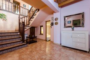 a hallway with a staircase and a mirror at Pula Viñas in Son Servera