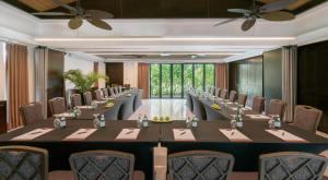 a large conference room with a long table and chairs at The Residence Bintan in Kawal