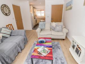 a living room with a couch and a table at 10 The Orchard in Colwyn Bay +21 photos