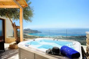 a jacuzzi tub with a view of the ocean at Stefanos Village Hotel in Plakias