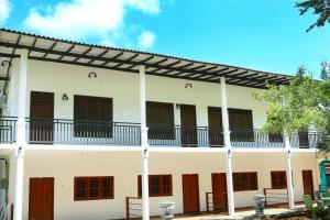 an exterior view of a building with a pergola at Emerald Guest House in Kataragama