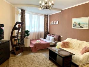 a living room with a couch and a living room with at Apartment Alla in Chernihiv