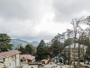 a small town with a mountain in the background at Sagrika Resort Dalhousie in Dalhousie