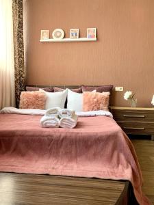a bedroom with a bed with two towels on it at Apartment Alla in Chernihiv