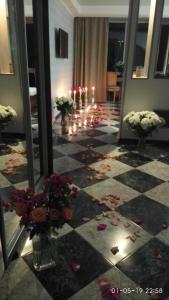 a room with candles and flowers on a checkerboard floor at Health complex Beliy Parus in Foros