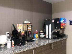 a kitchen counter with two refrigerators and a microwave at Catoosa Inn & Suites in Catoosa