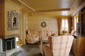 Chalet Obelix في جريندلفالد: غرفة معيشة مع كنبتين ومدفأة