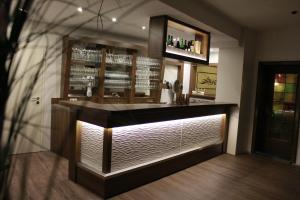 a bar with a counter in a room at Ummen Hotel&Restaurant in Barßel