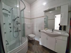 a bathroom with a sink and a shower and a toilet at Amazing sea view apartments Ljubic in Pag +60 photos