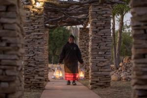 a man walking down a path through an archway at Karongwe River Lodge in Karongwe Game Reserve
