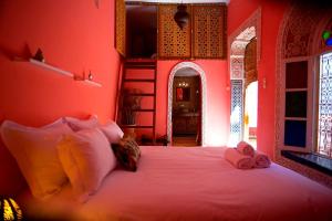 a bedroom with a bed and a window at Riad Safir in Meknès