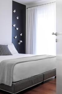 A bed or beds in a room at The H Experience Boutique Apartment Koules Fortress Heraklion