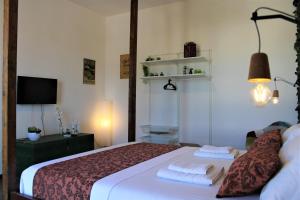 a bedroom with a bed with two pillows on it at Terre di Sicilia in Marsala