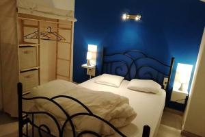 a blue bedroom with a bed and a blue wall at Ax Vacances Famille in Ax-les-Thermes