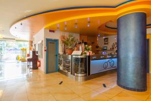 a restaurant with a counter in a building at Hotel Senior in Cattolica